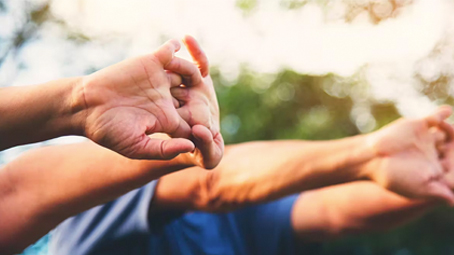 Two men stretching their wrists and fingers
